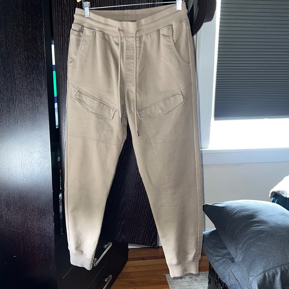 Dark Tan Joggers with back and front pockets cuffed in the bottom.